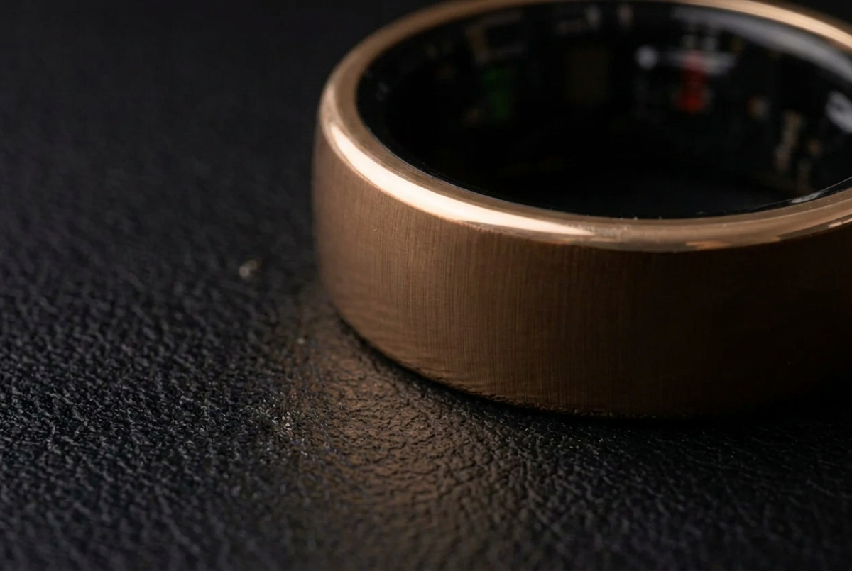 Macro side view of the ChiroRing Bronze Gold showing the brushed satin grain of the band